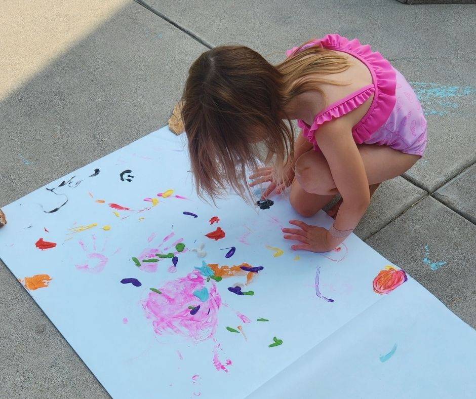 Outdoor Finger Painting Fun: A Simple Sensory Activity for Kids.